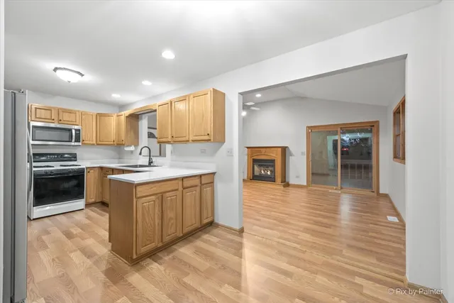 a kitchen with granite countertop a stove top oven and cabinets