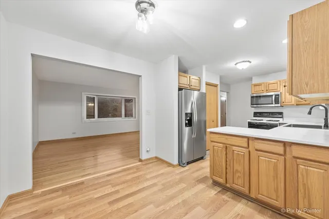 a kitchen with stainless steel appliances a refrigerator and a sink