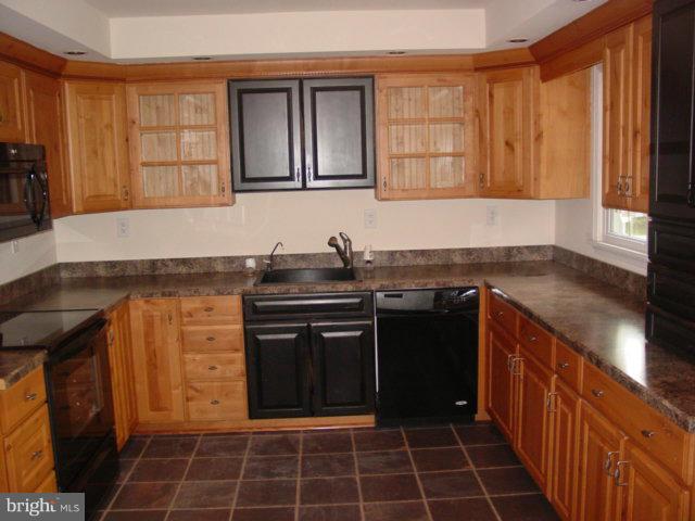 17914 Marshall Mill Road Hampstead, MD 21074 - Photo 4 of 17 a kitchen with a sink stove and cabinets