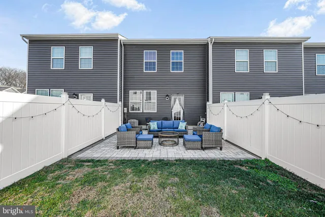 a view of a house with backyard and a patio