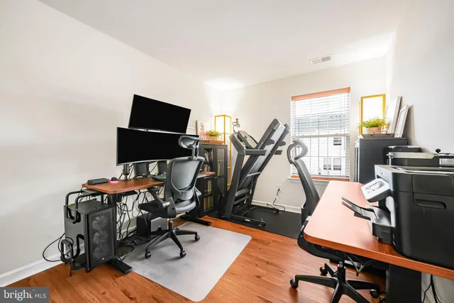 a view of a workspace with furniture and a window