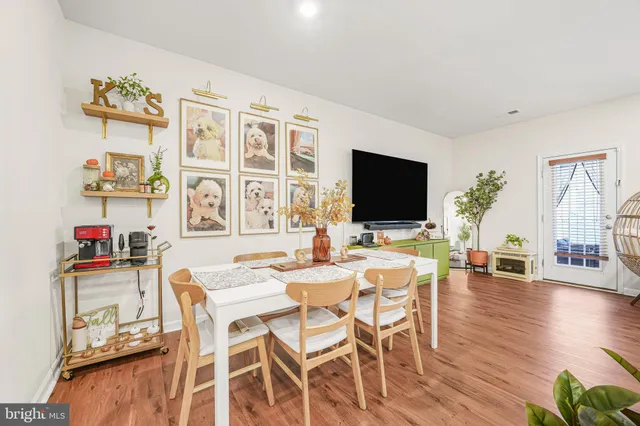 a view of a dining room with furniture wooden floor and a flat screen tv