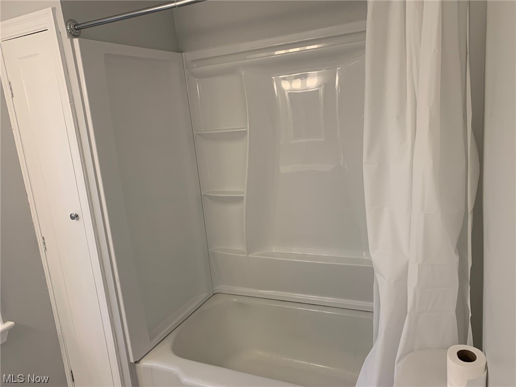 1456 Evanston Road Lyndhurst, OH 44124 - Photo 13 of 32 Bathroom featuring shower / bathtub combination with curtain and toilet