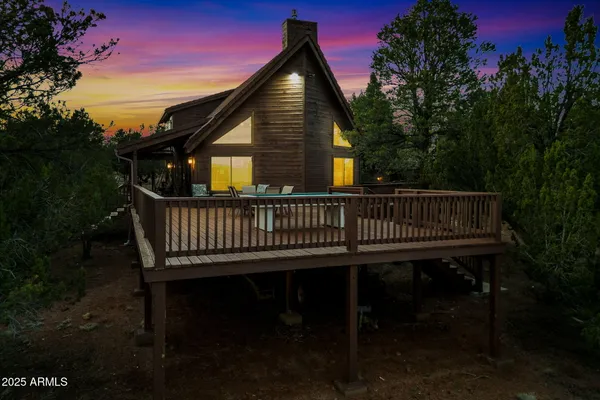 a view of a roof deck with wooden fence and floor