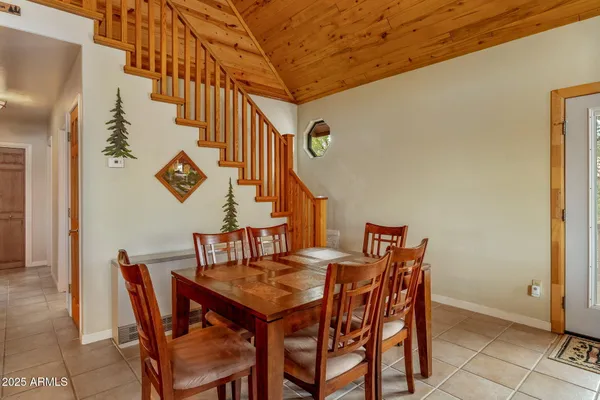 a kitchen with sink refrigerator dining table and chairs