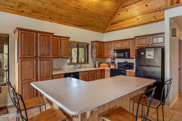 a large kitchen with kitchen island a large island in the center