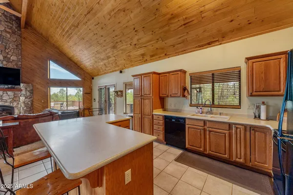 a kitchen with stainless steel appliances granite countertop a sink a stove and refrigerator