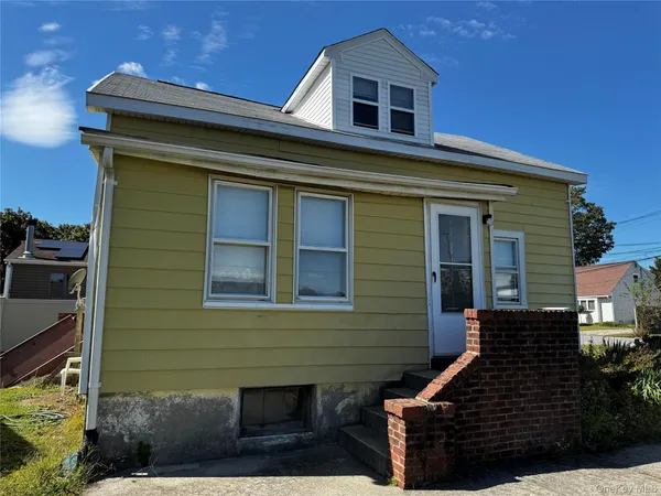 a front view of a house with stairs