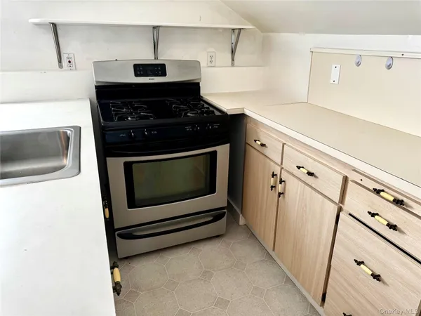 a kitchen with white cabinets and appliances