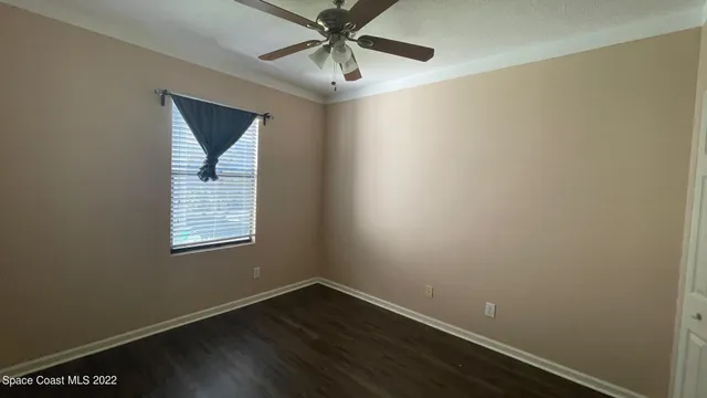 a view of a yard with wooden fence