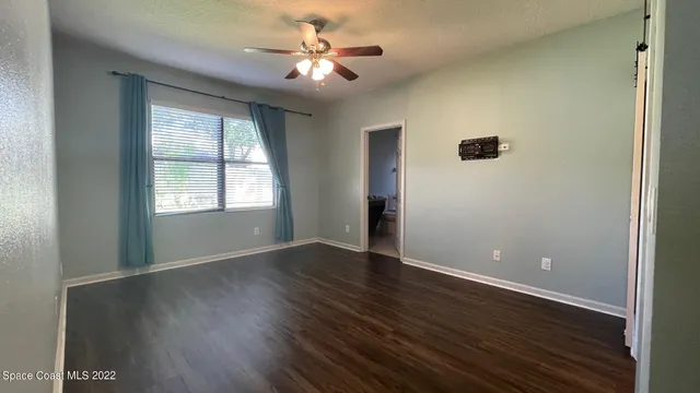 a view of a small space with wooden floor and a window