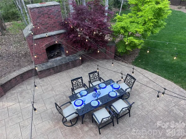 a backyard of a house with table and chairs