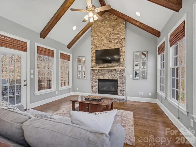a living room with fireplace furniture and a wooden floor