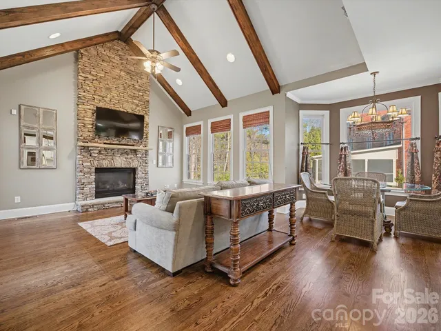 a living room with furniture and floor to ceiling windows