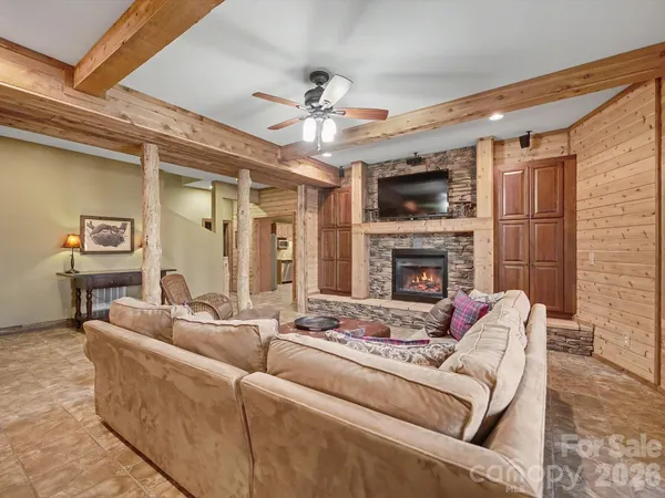 a living room with furniture fireplace and flat screen tv