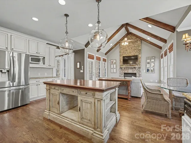 a bedroom with a bed lamp and a chandelier