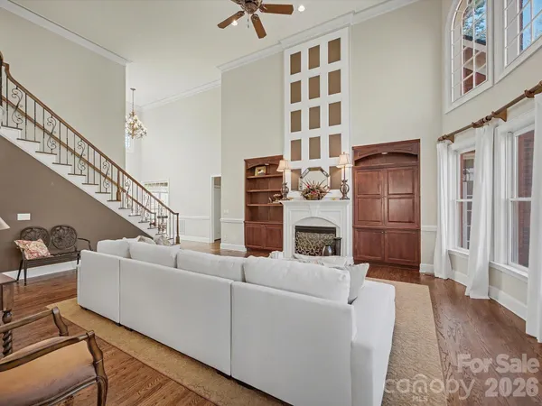 a living room with furniture a fireplace and a book shelf