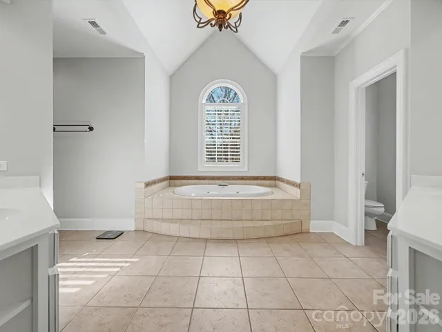 a spacious bathroom with a granite countertop sink a mirror and a