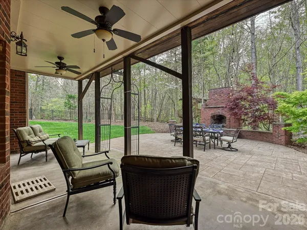 a living room with patio furniture and a floor to ceiling window