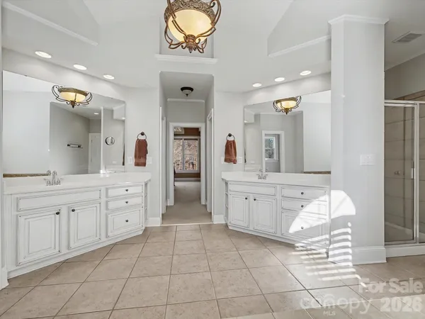 a spacious bathroom with a granite countertop sink a mirror and a