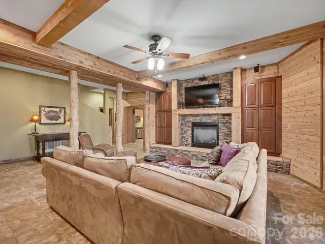 a living room with furniture a flat screen tv and a fireplace