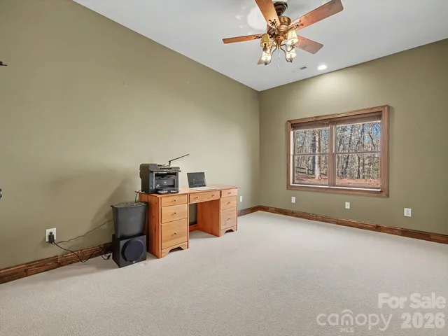 a bathroom with a granite countertop sink mirror and toilet