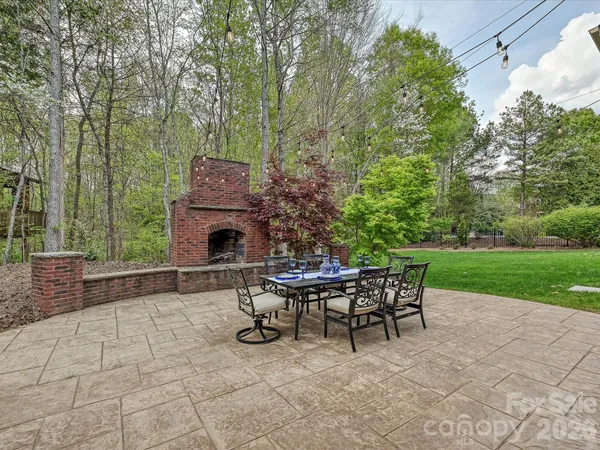 a view of a chairs and table in backyard of the house