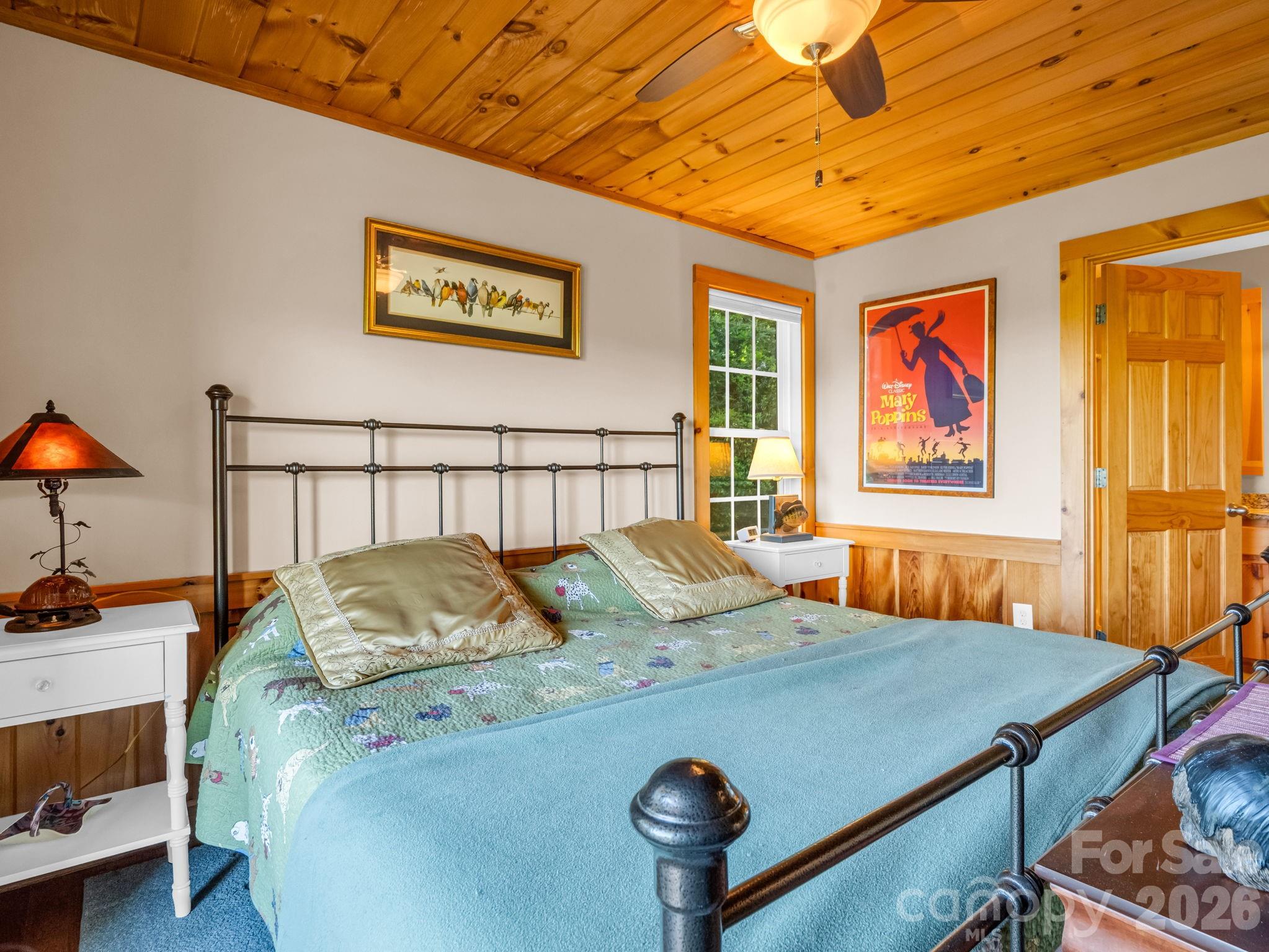 603 Pace Mountain Road Saluda, NC 28773 - Photo 21 of 44 a bedroom with a bed and wooden floor