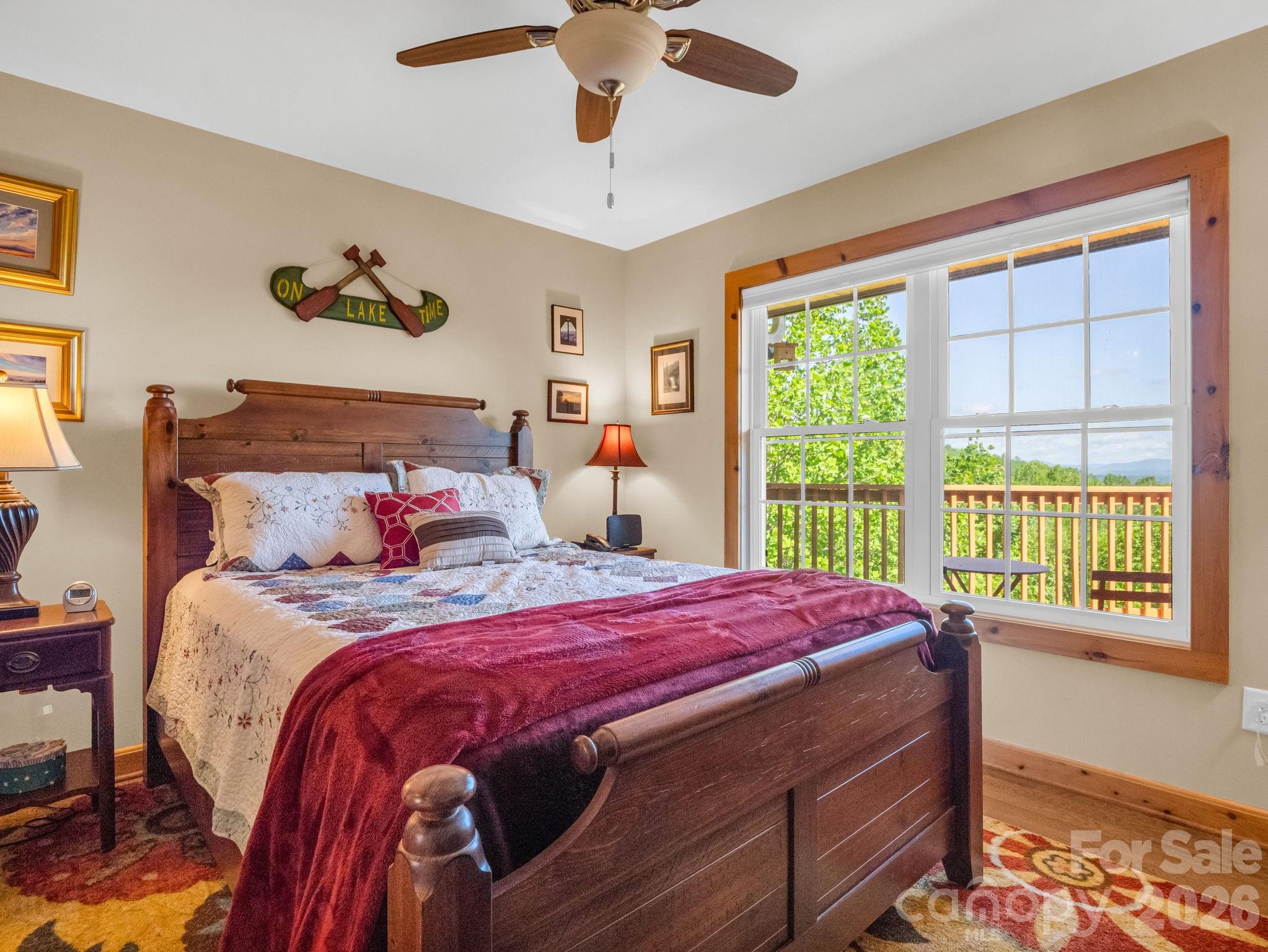 603 Pace Mountain Road Saluda, NC 28773 - Photo 26 of 44 a bedroom with a bed and a large window