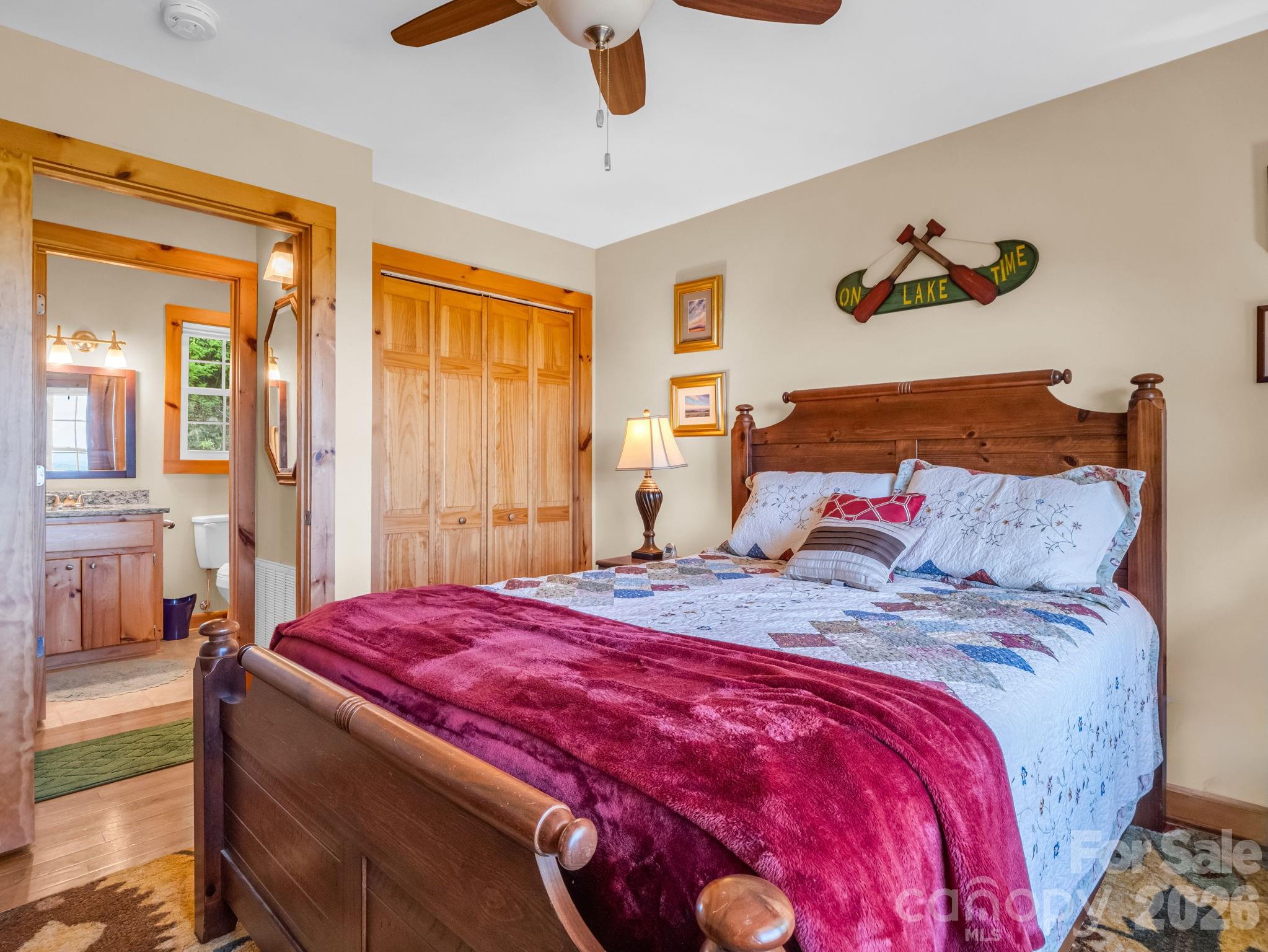 603 Pace Mountain Road Saluda, NC 28773 - Photo 27 of 44 a bedroom with a bed and a painting on the wall