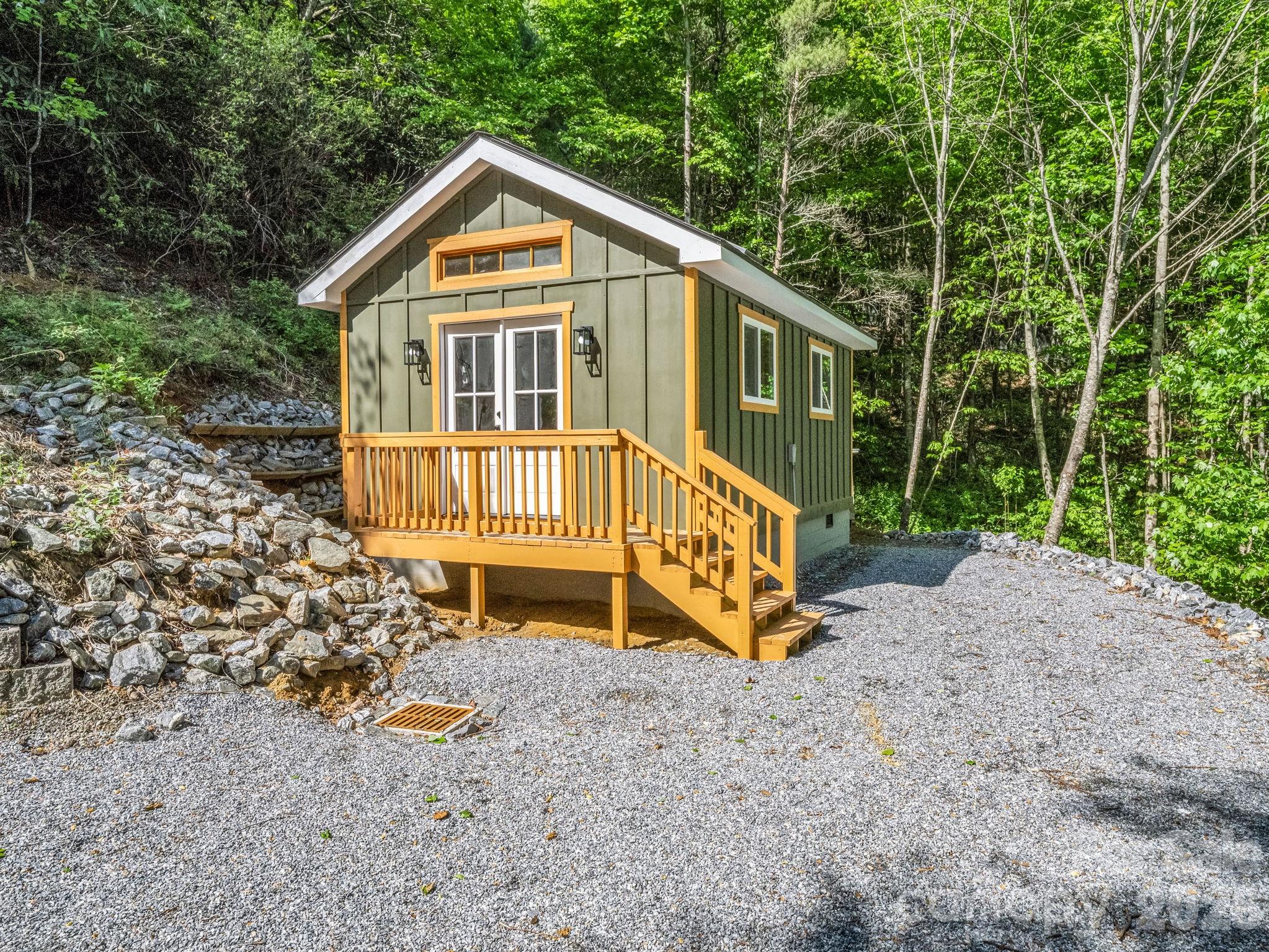 603 Pace Mountain Road Saluda, NC 28773 - Photo 31 of 44 a view of a house with a yard chairs and wooden fence