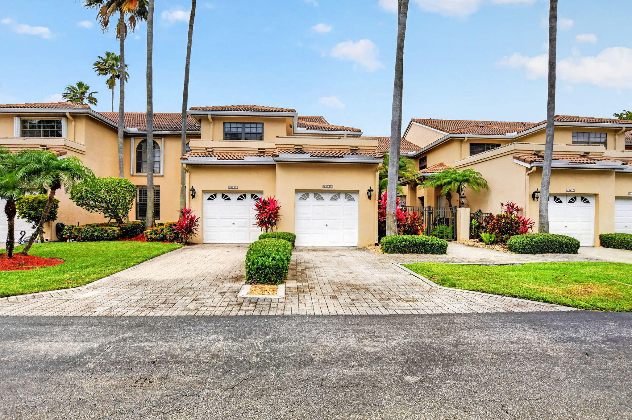 a front view of a house with a yard and a garage