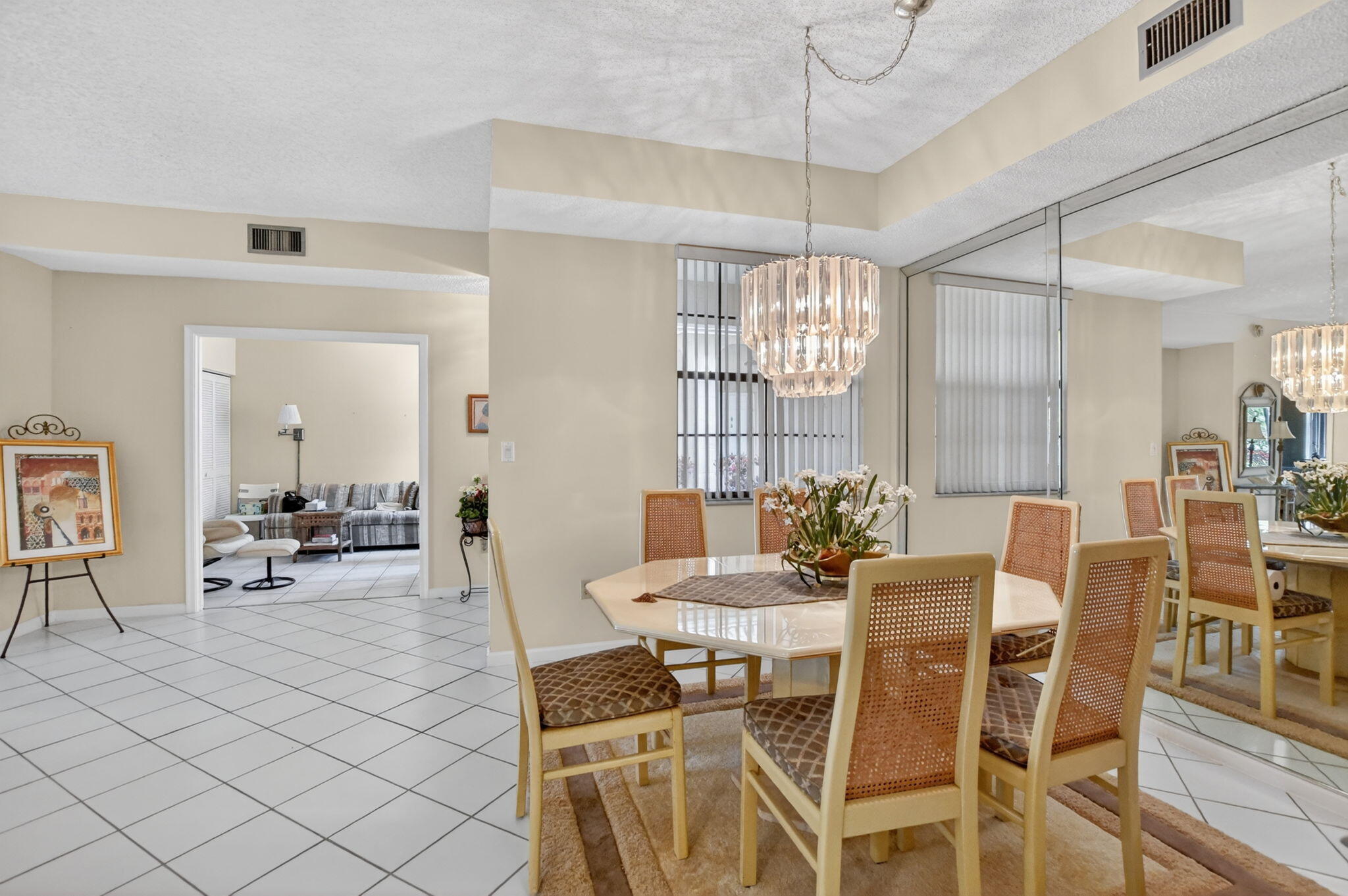 6683 Montego Bay Boulevard, Unit C Boca Raton, FL 33433 - Photo 12 of 37 a view of a dining room with furniture and chandelier