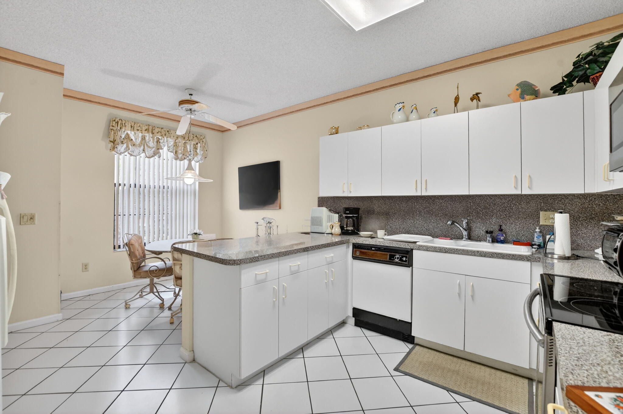 6683 Montego Bay Boulevard, Unit C Boca Raton, FL 33433 - Photo 16 of 37 a kitchen with a sink cabinets and window