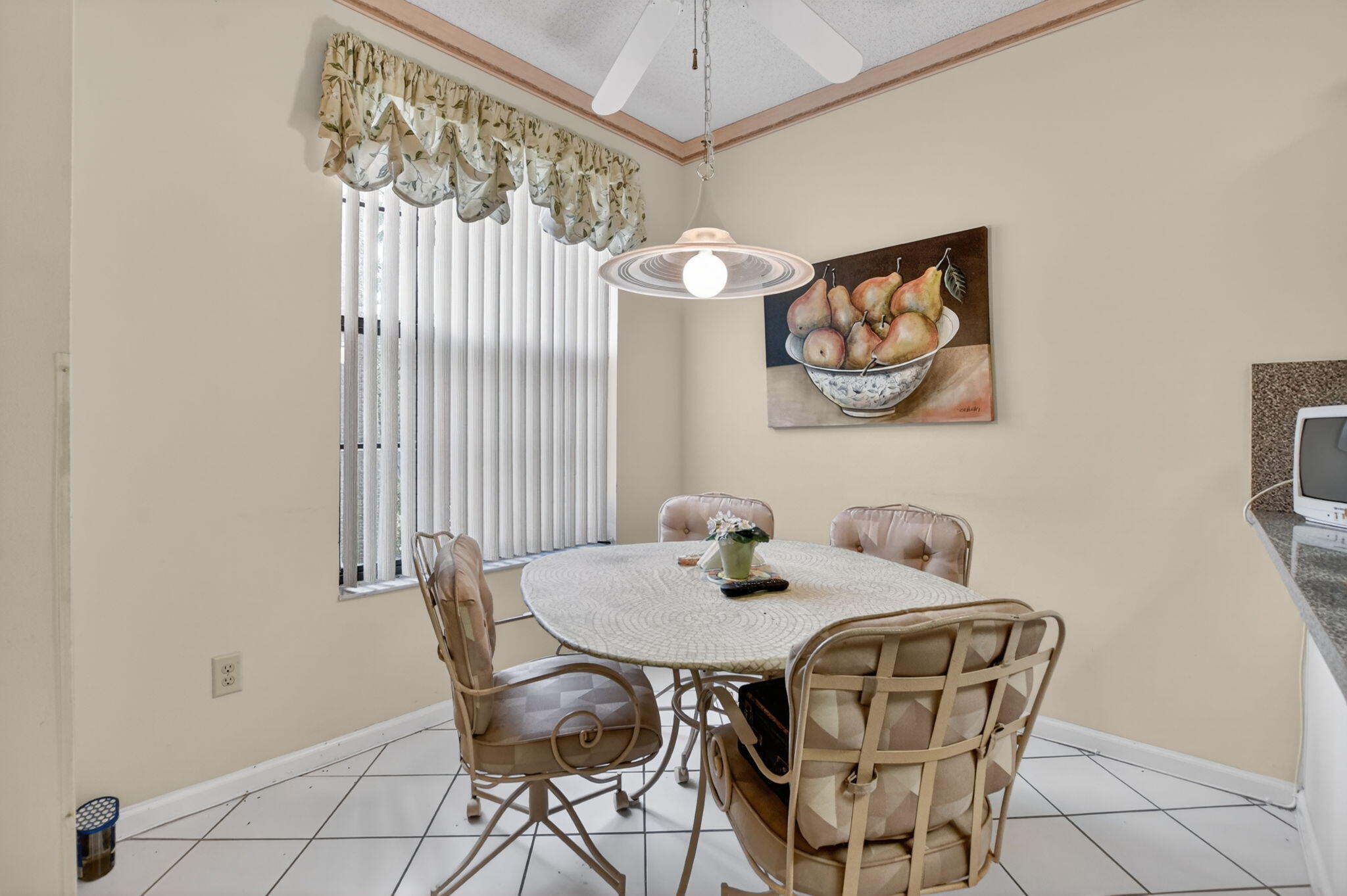 6683 Montego Bay Boulevard, Unit C Boca Raton, FL 33433 - Photo 19 of 37 a view of a dining room with furniture and a chandelier fan