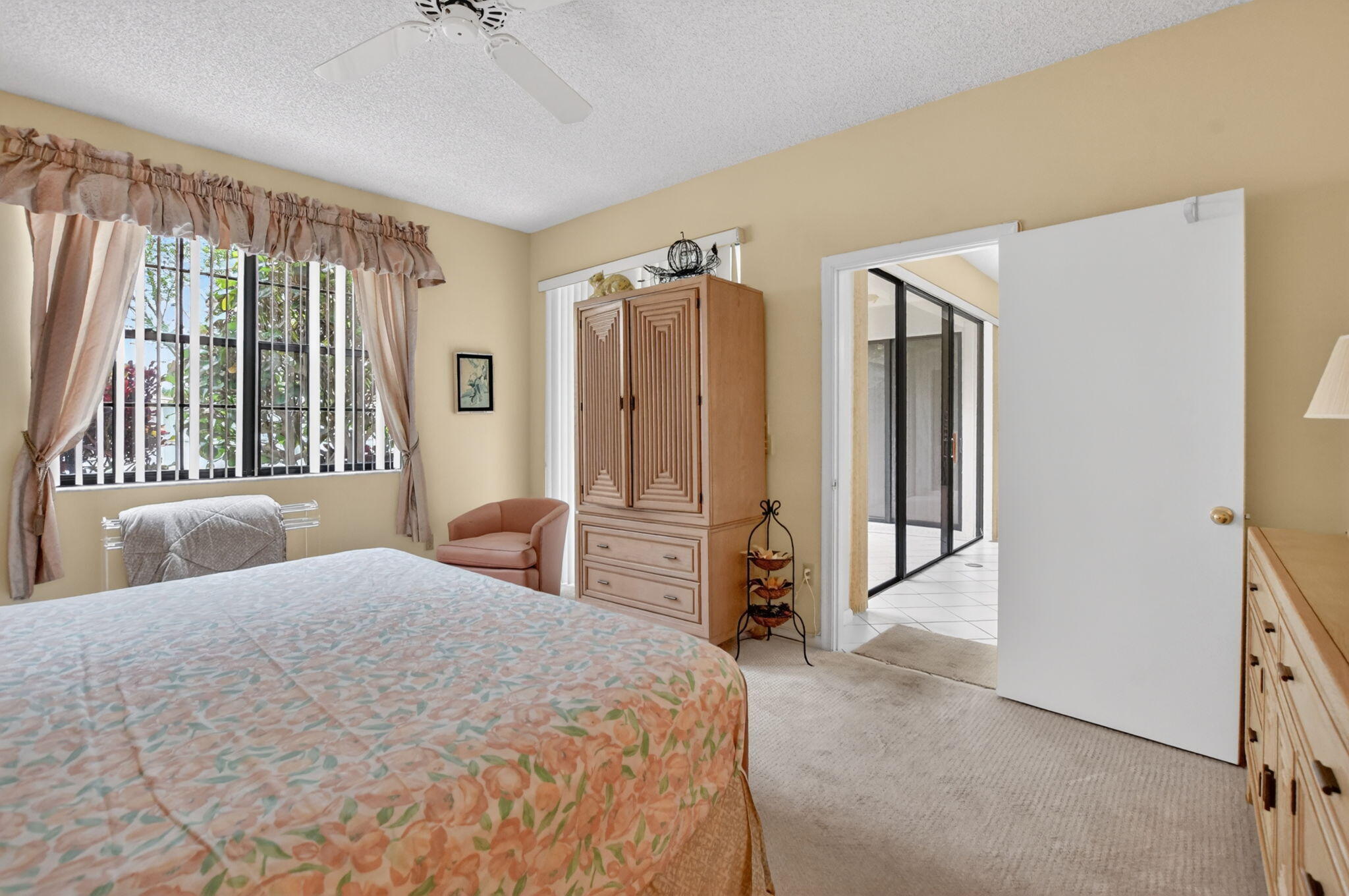 6683 Montego Bay Boulevard, Unit C Boca Raton, FL 33433 - Photo 22 of 37 a bedroom with a large bed and a dresser