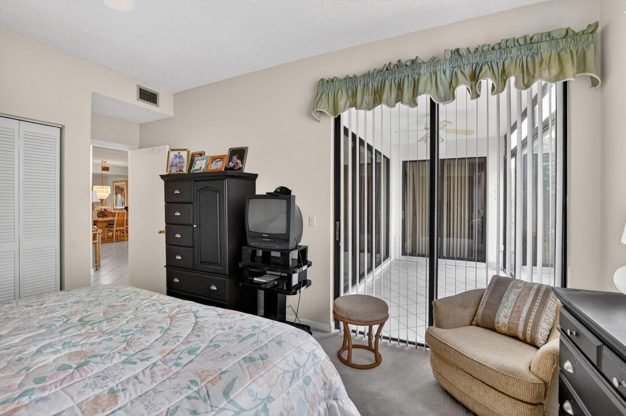6683 Montego Bay Boulevard, Unit C Boca Raton, FL 33433 - Photo 27 of 37 a bedroom with a bed closet and a large mirror