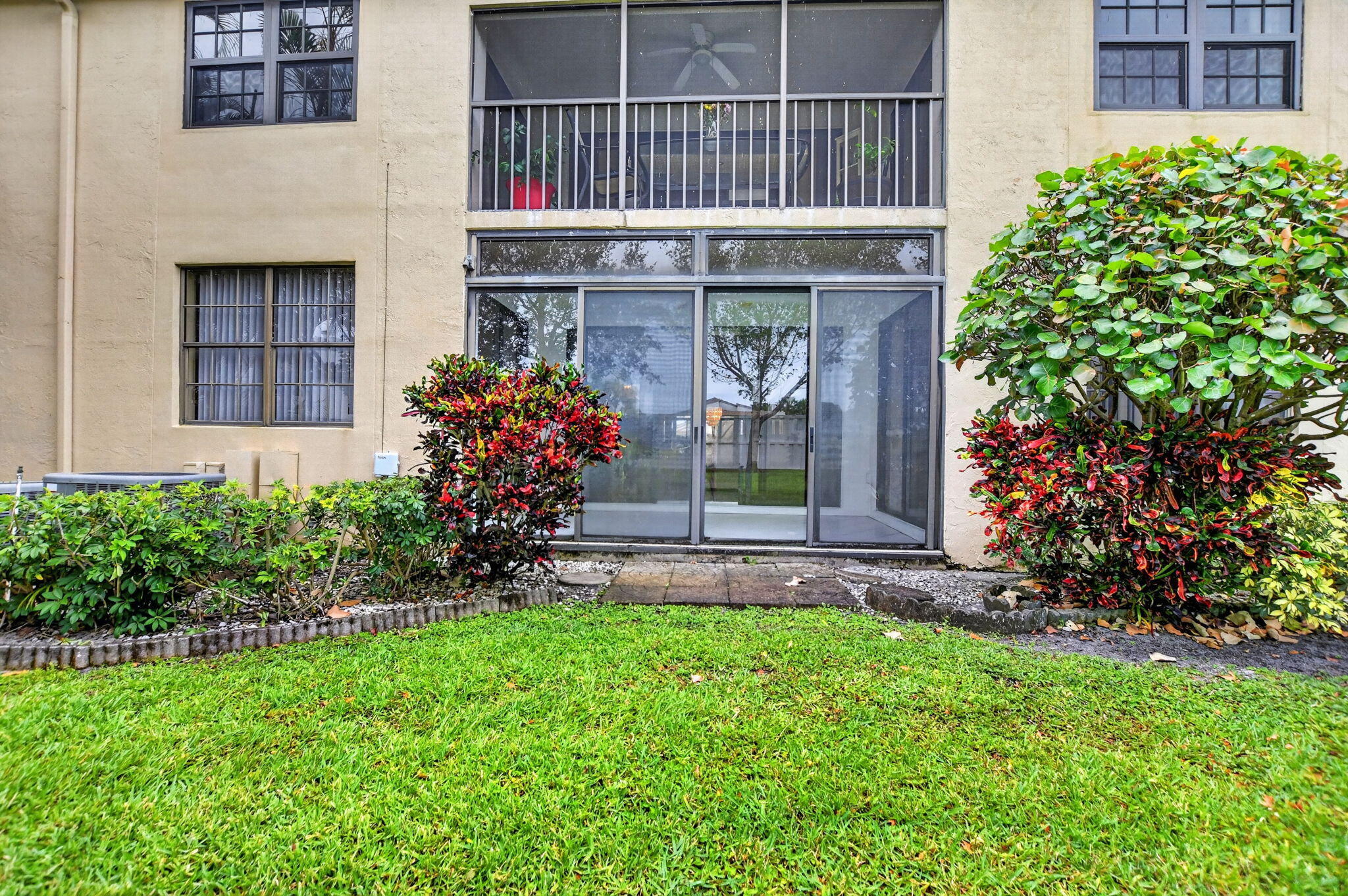 6683 Montego Bay Boulevard, Unit C Boca Raton, FL 33433 - Photo 33 of 37 a front view of a house with a garden