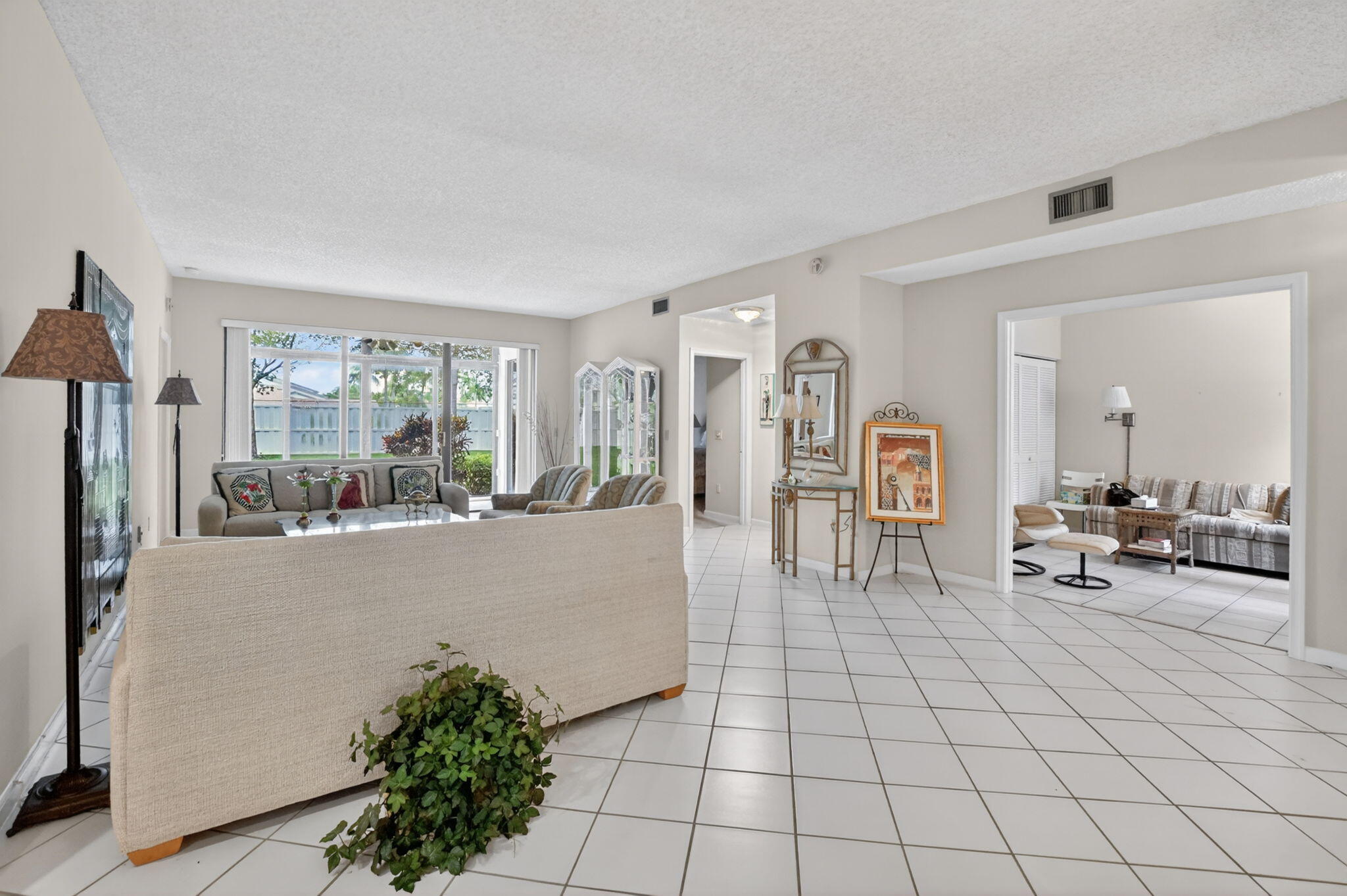 6683 Montego Bay Boulevard, Unit C Boca Raton, FL 33433 - Photo 7 of 37 a living room with furniture and a large window