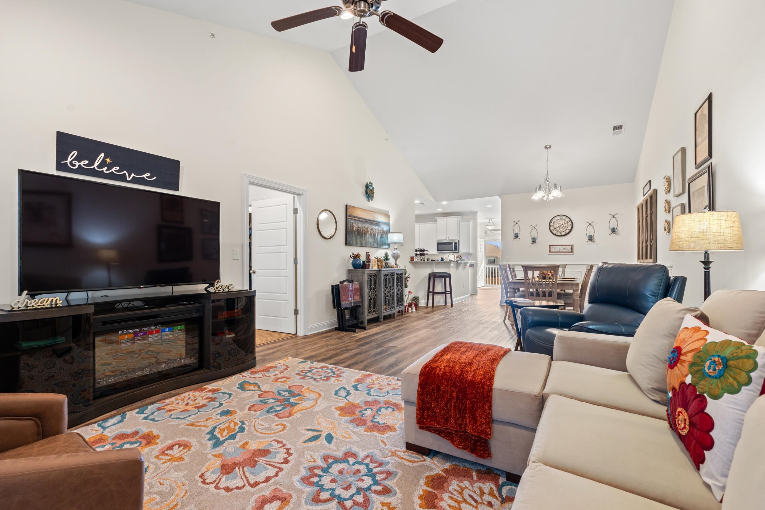 900 Jackline Place, Unit 202 Murrells Inlet, SC 29576 - Photo 22 of 39 Living room with a ceiling fan, wood finished floors, high vaulted ceiling, and a chandelier