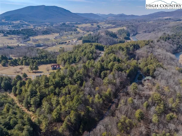 an aerial view of residential house and sandy dunes