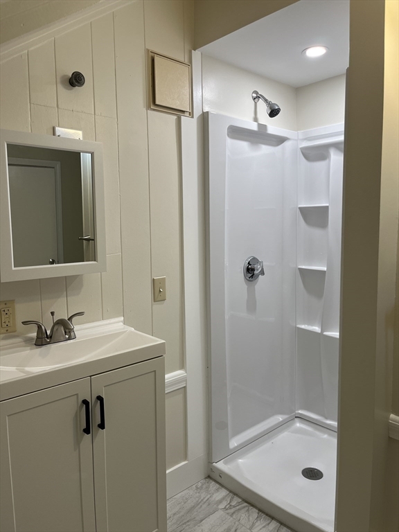 29 Ripley Road Belmont, MA 02478 - Photo 23 of 29 a bathroom with a shower sink and mirror