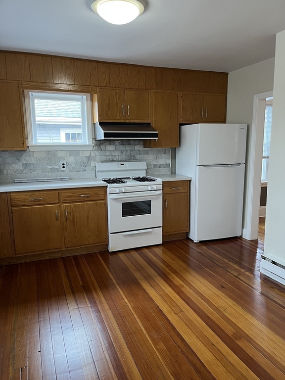 29 Ripley Road Belmont, MA 02478 - Photo 3 of 29 a kitchen with wooden floors and white stainless steel appliances