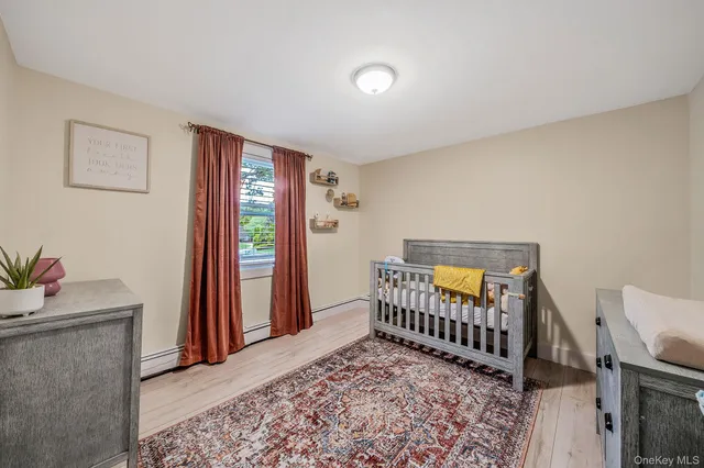 a bedroom with a bed and a tv on the dresser