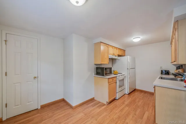 a kitchen with a sink a stove and cabinets