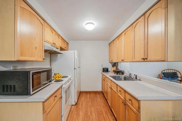 a view of a room with wooden floor and ceiling fan