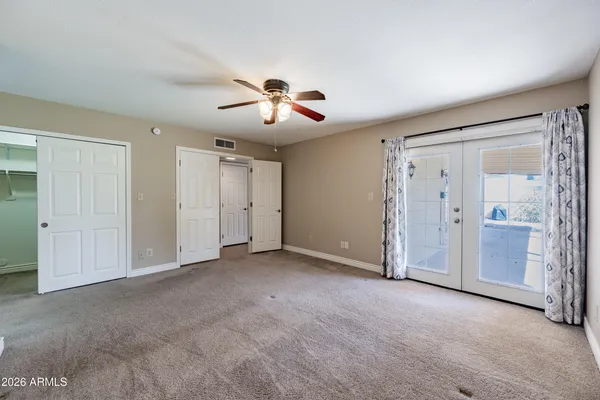 a view of empty room with ceiling fan