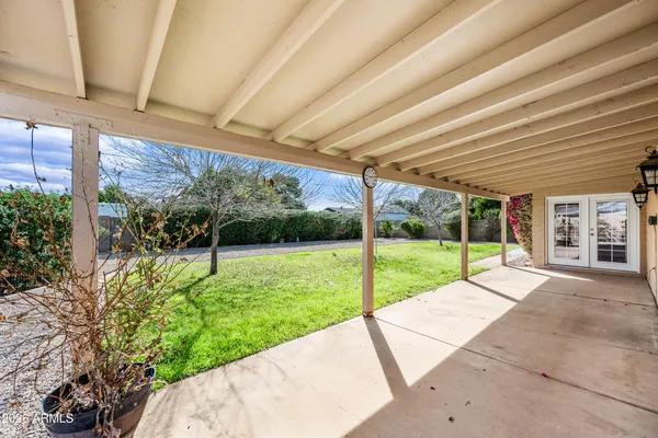 a view of a house with backyard and porch