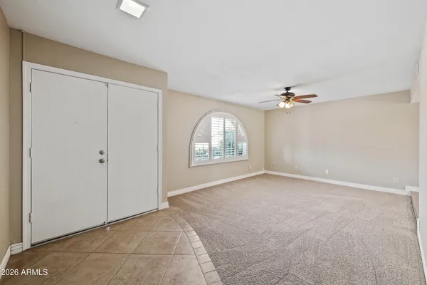 an empty room with windows and closet