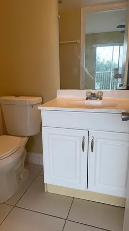 a bathroom with a sink a toilet and a mirror